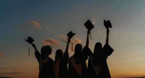 College graduates looking off in the distance.